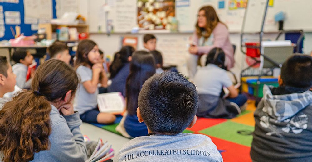 students sitting on floor in classroom