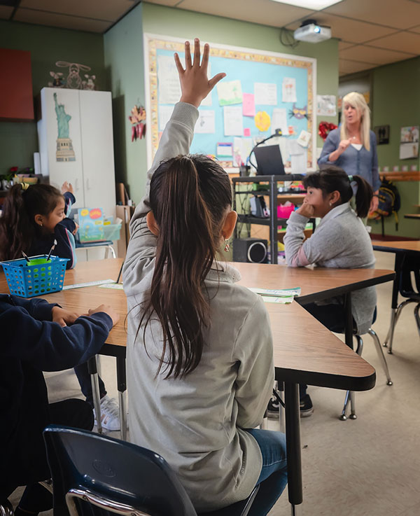 Student raising her hand in class