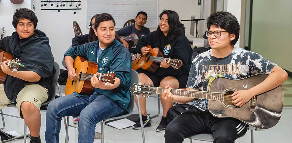 Students playing guitar in class