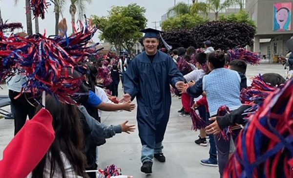 Student celebrating with cap and gown